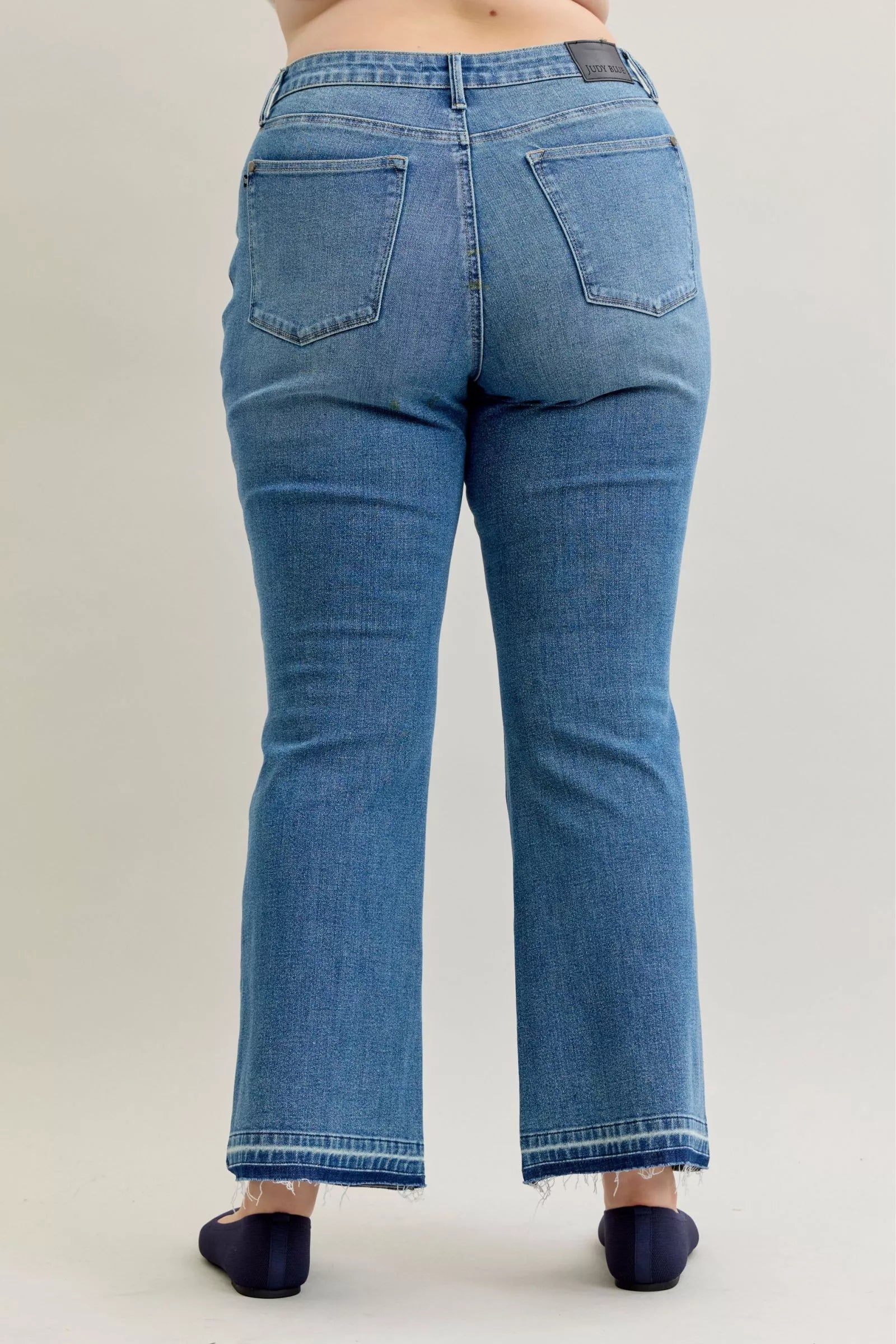 Judy Blue Full Size Mid Rise Slim Bootcut Tummy Control Release Hem Jeans Plus Size by Trendsi