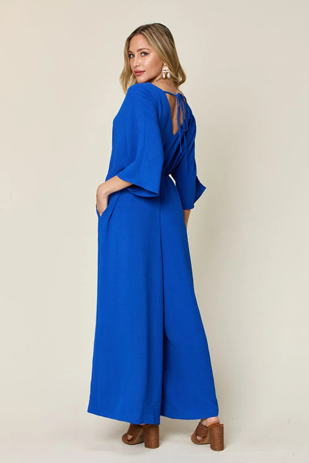 Double Take Full Size Surplice Wide Leg Jumpsuit with Pockets by Trendsi